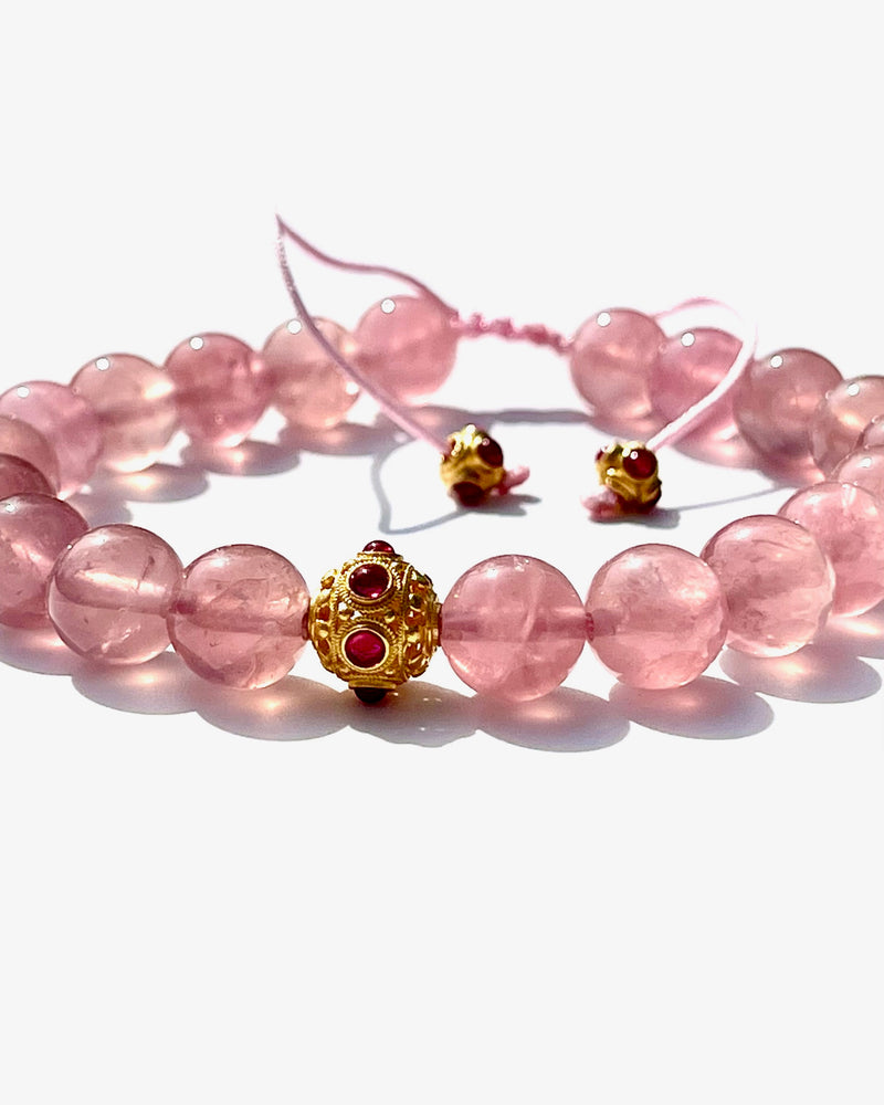 Madagascar "Jelly" Rose quartz with chatoyance and stars.  The Madagascar rose quartz is an embodiment of the Love frequency, Divine Love.  The "Jelly" Rose quartz, may look brownish at night, its real beauty shine against the skin. The color is very different from the normal pale rose quartz. (You have to be prepared to be surprised by it, if you received it at night). It is truly a magnificent and rare mineral specimen.  Madagascar "Jelly" starRose quartz beads, in the middle one 18k gold beads with hot p