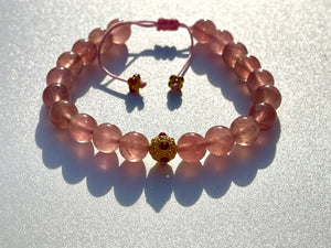 Madagascar "Jelly" Rose quartz with chatoyance and stars.  The Madagascar rose quartz is an embodiment of the Love frequency, Divine Love.  The "Jelly" Rose quartz, may look brownish at night, its real beauty shine against the skin. The color is very different from the normal pale rose quartz. (You have to be prepared to be surprised by it, if you received it at night). It is truly a magnificent and rare mineral specimen.  Madagascar "Jelly" starRose quartz beads, in the middle one 18k gold beads with hot p