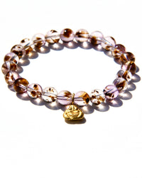 Stretch bracelet, beads made of Cacoxenite Amethyst.   Each beads has wisps of golden cacoxenite. The beads are crystal clear and full of Light. This is truly a magnificent strandSmall 18k gold laughing Buddha.