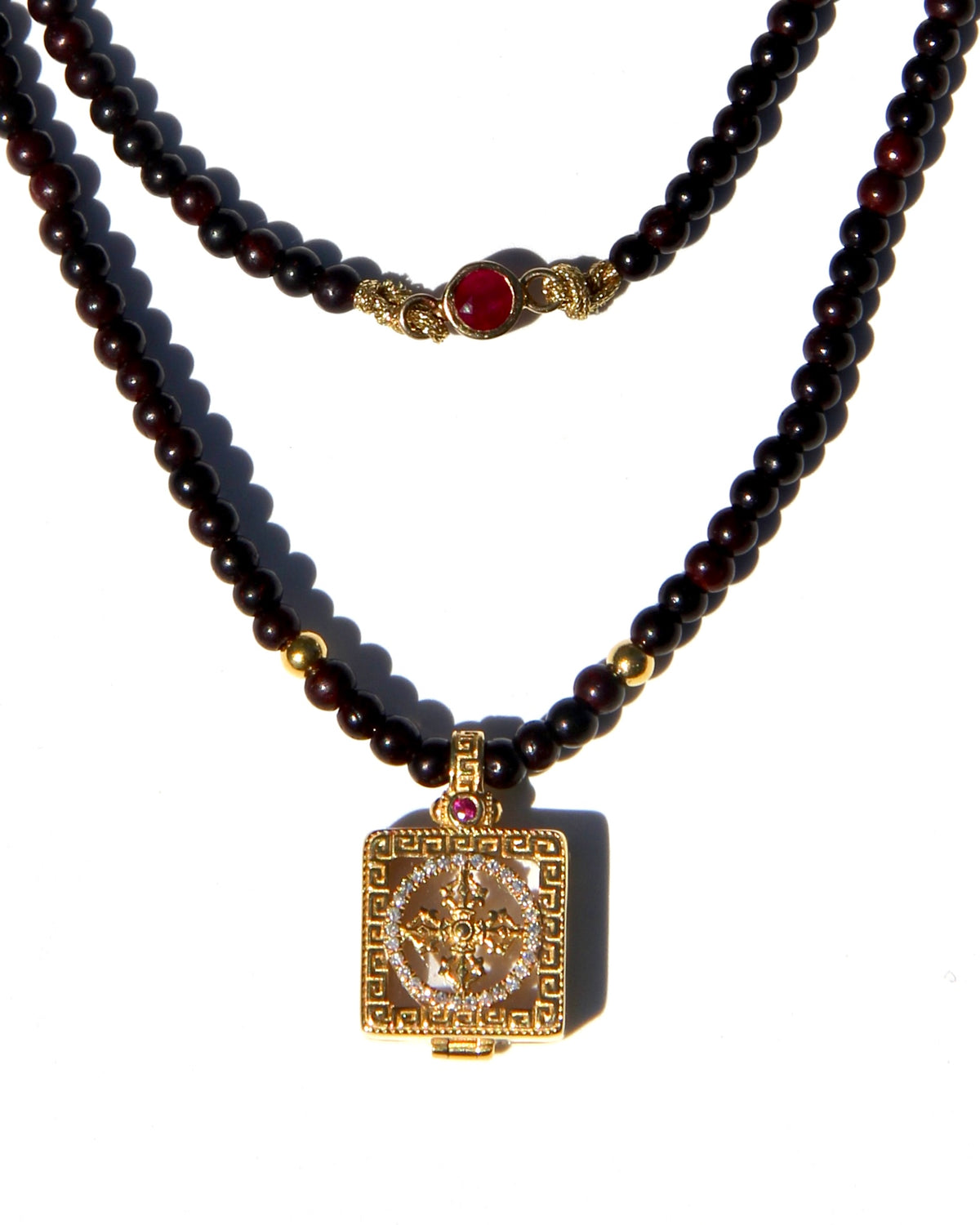 Miniature Treasure box, with a double vajra / dorje made of 18k gold, white diamonds and one sapphire and one ruby.  The beads are handmade antique sandalwood beads (thus the color), each bead can be grounded into dusts and burned as pure sandalwood incense.  Sold with Magical dusts to fill the miniature box.  Necklace length: 56cms. Each bead: 2,5mms.