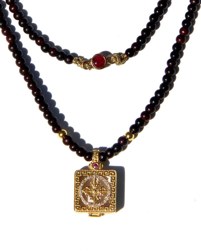 Miniature Treasure box, with a double vajra / dorje made of 18k gold, white diamonds and one sapphire and one ruby.  The beads are handmade antique sandalwood beads (thus the color), each bead can be grounded into dusts and burned as pure sandalwood incense.  Sold with Magical dusts to fill the miniature box.  Necklace length: 56cms. Each bead: 2,5mms.