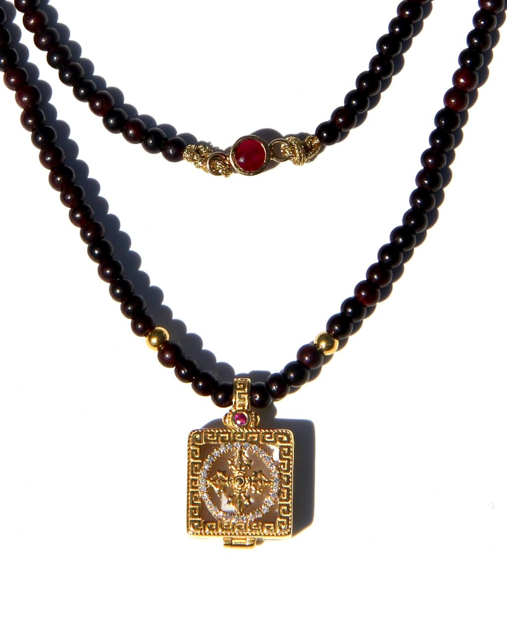 Miniature Treasure box, with a double vajra / dorje made of 18k gold, white diamonds and one sapphire and one ruby.  The beads are handmade antique sandalwood beads (thus the color), each bead can be grounded into dusts and burned as pure sandalwood incense.  Sold with Magical dusts to fill the miniature box.  Necklace length: 56cms. Each bead: 2,5mms.