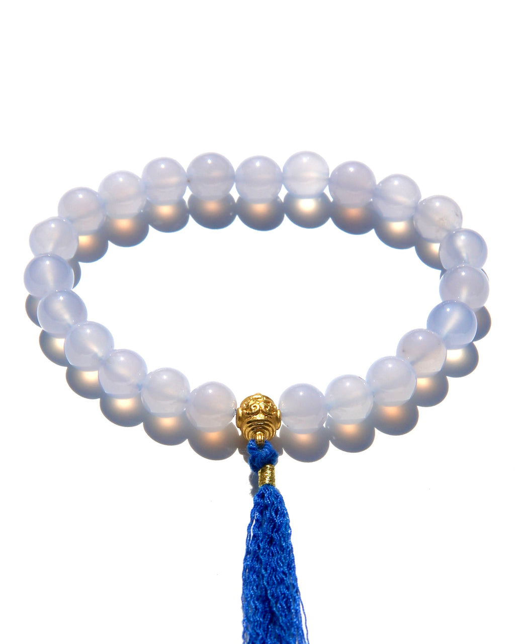 The Healers bracelet, blue chalcedony.  With a 24k gold bead and blue cotton tassel.  Blue chalcedony helps create the Sacred voice. It also has strong color healing abilities.