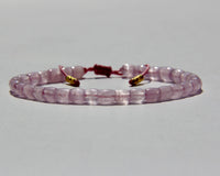 The Healer's bracelet , Kunzite mini.  Small kunzite beads with two 24K gold beads, with circles pattern (symbols of the Core , the center of the Higher Heart) drawn on them.