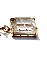 Enhydro quartz extremely clear with 6 water bubbles.  14 k yellow gold with diamonds on each corner.  Enhydro quartz creates a link between Heaven and Earth.