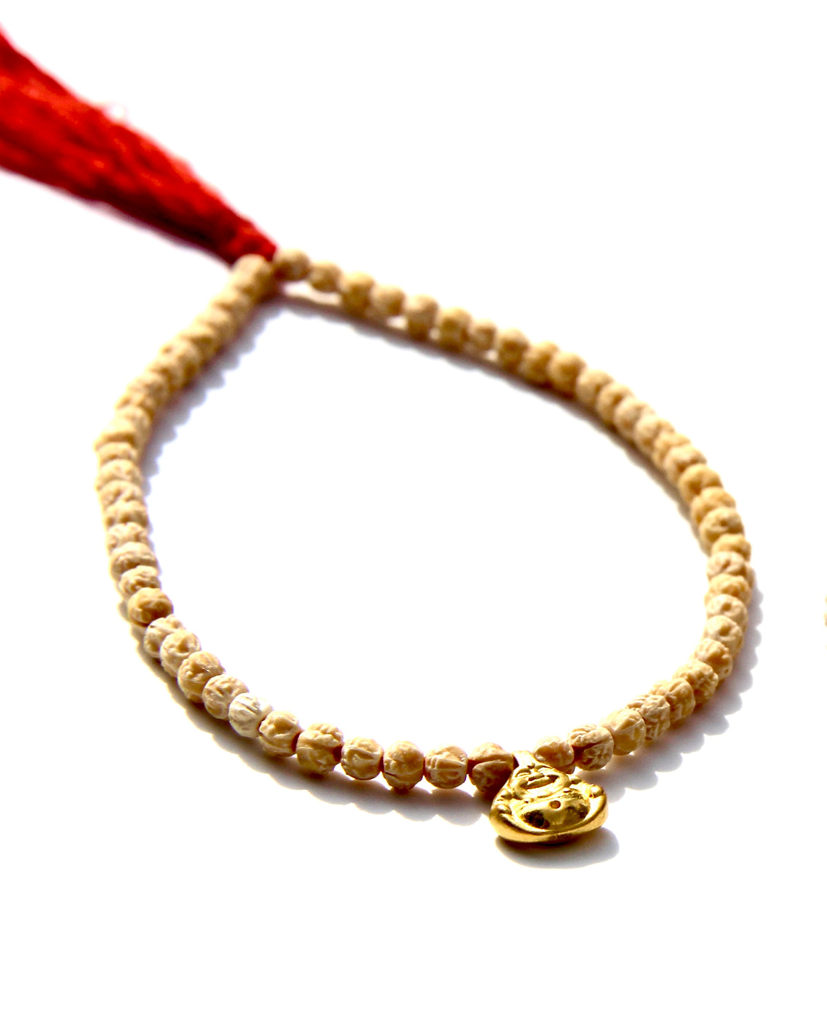 The Minis, a collection of tiny bracelets exploring the Universe of symbolism, made of Rudraksha beads strung on red thread, gold beads ....   This bracelet is made of Rudraksha beads with a 24k small laughing buddha.  Buddha size: 8mm
