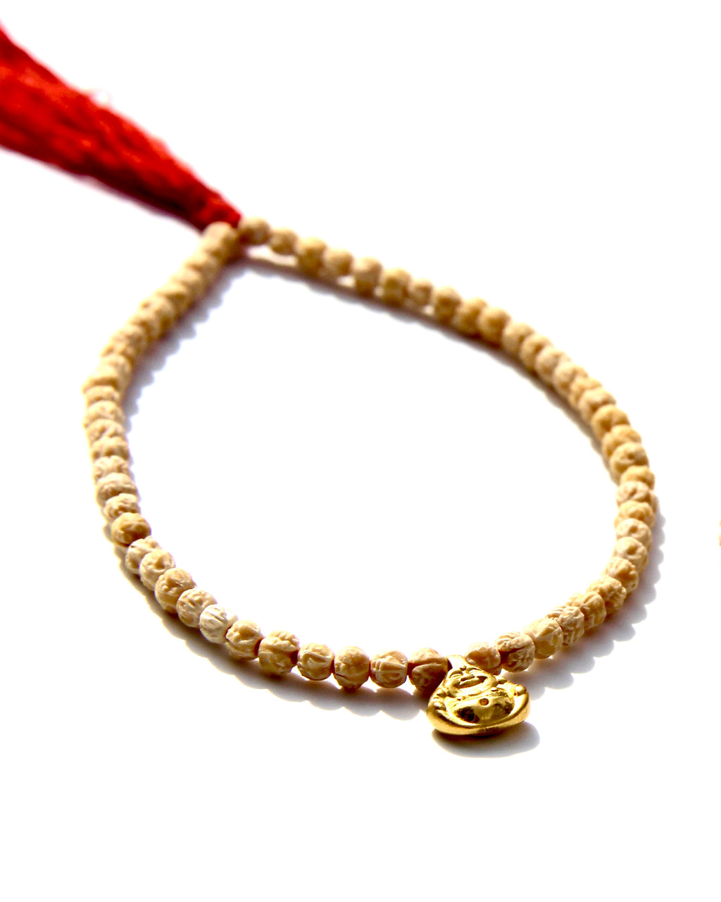 The Minis, a collection of tiny bracelets exploring the Universe of symbolism, made of Rudraksha beads strung on red thread, gold beads ....   This bracelet is made of Rudraksha beads with a 24k small laughing buddha.  Buddha size: 8mm